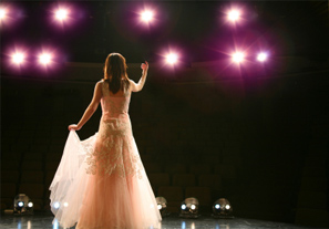 A women performing on stage.